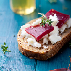 Crostini, bruschetta with plum, berry marmalade and goat cheese 