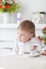 Beautiful happy blond boy holding a carrot