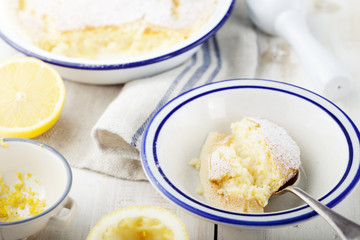 Lemon pudding cake with fresh lemons. Wooden background