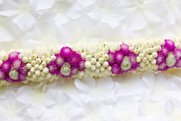 Close up of Globe Amaranth and Jasmine garland.