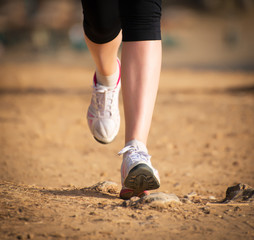 Female legs during workout in the forest.