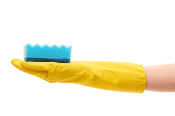 Close up of female hand in yellow protective rubber glove holding blue cleaning sponge against white background