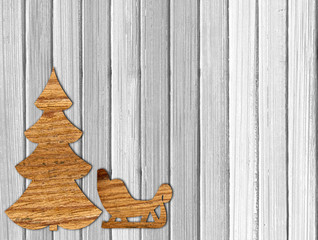Fototapeta na wymiar Plywood Christmas tree and sleigh on white wooden background