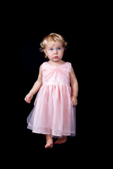 Portrait of beautiful elegant baby girl on black background,