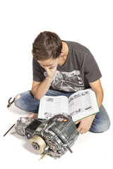 Teenage Boy Fixing An Engine