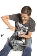 Teenage Boy Fixing An Engine