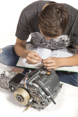 Teenage Boy Fixing An Engine