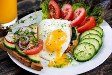 Morning Breakfast - vegan toast sandwich, egg, bacon, and vegetables.