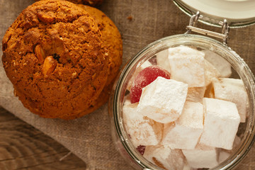 Oatmeal biscuits and jar with sweeties top view