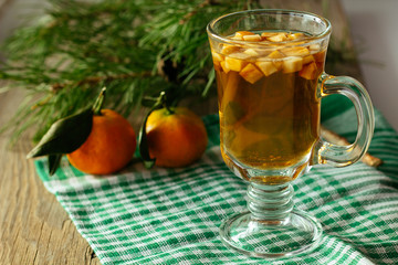 Glass of christmas punch and tangerine