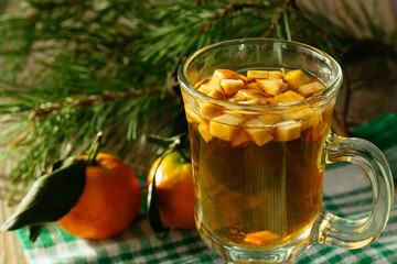 Glass of christmas punch with fruits and tangerine