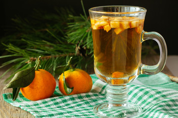 Glass of christmas punch with fruits and tangerines