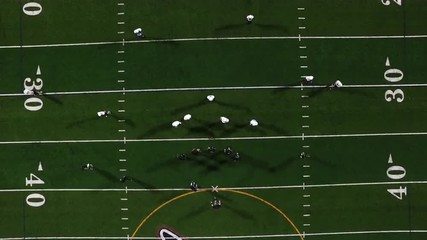 Football players line up at the line of scrimmage, birds eye view from high up