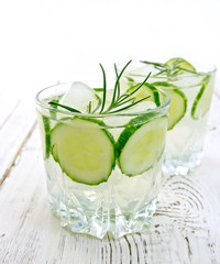 Lemonade with cucumber and rosemary in two glassful on table