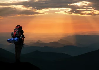 Fotobehang view of man on mountains with big rucksack on back © Daniel Prudek
