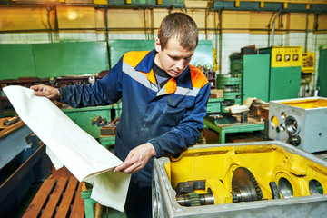 Fototapeta na wymiar industrial worker assembling the reduction gear box