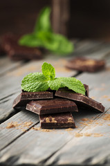 Dark chocolate with mint on the vintage table