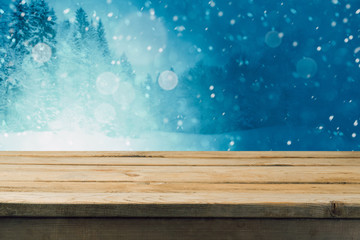 Empty wooden table over winter forest background. Mock up table template for product montage