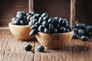 Fresh red grape on the wooden table