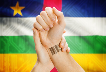 Barcode ID number on wrist and national flag on background - Central African Republic