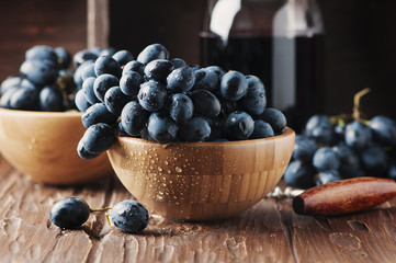 Fresh grape and red wine on the vintage table
