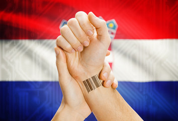 Barcode ID number on wrist and national flag on background - Croatia