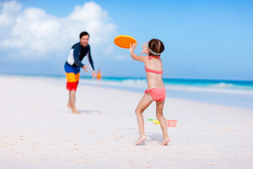 Father and daughter playing with flying disk