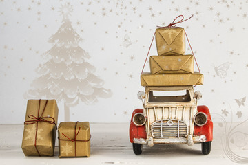 Christmas holiday concept with gift boxes on toy car