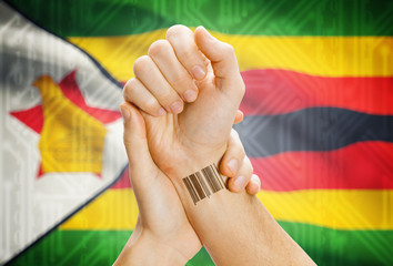 Barcode ID number on wrist and national flag on background - Oman