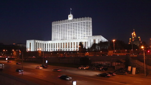 Night traffic on Krasnopresnenskaya embankment overlooking the Government House of the Russian Federation at night
