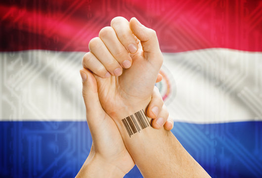 Barcode ID number on wrist and national flag on background - Paraguay - Powered by Adobe