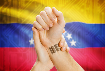 Barcode ID number on wrist and national flag on background - Venezuela