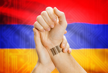 Barcode ID number on wrist and national flag on background - Armenia