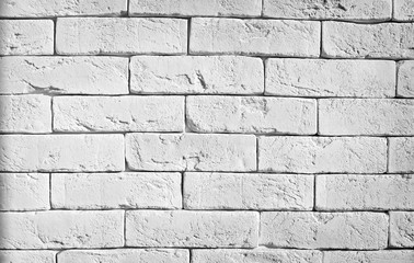 Obraz premium Brick wall texture in white painted masonry features clean horizontal rows, subtle mortar shadows, and a rustic loft surface finish for modern interior design background projects