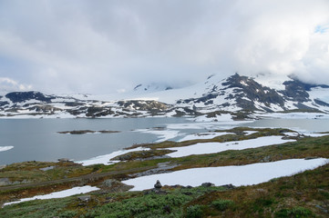 Fototapeta na wymiar Winter highland lake and snowy mountains of Norway