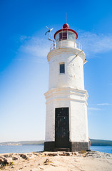 Fototapeta na wymiar Lighthouse Tokarevskaya koshka with vane anemometer in Vladivost