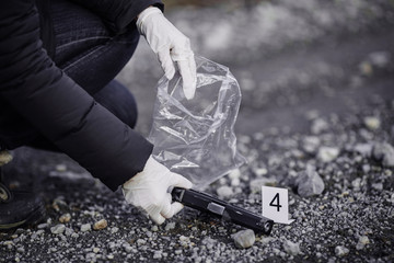 Crime scene investigation - collecting pistol on way