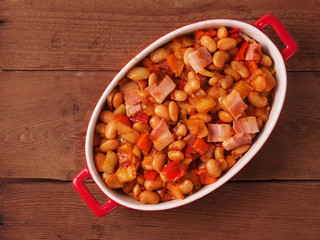Beans and bacon prepared for baking in oven