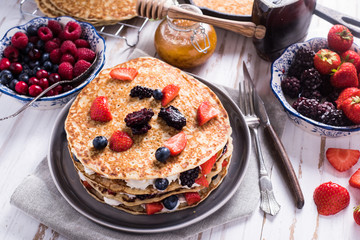 Traditional breakfast with pancakes and fruits