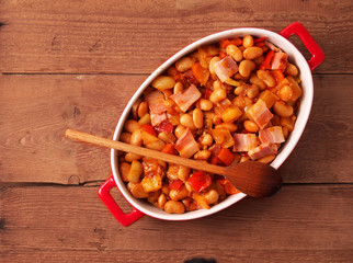 Beans and bacon prepared for baking in oven