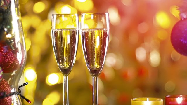 two glasses of champagne ready for christmas celebration, on purple background