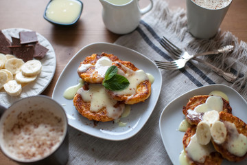 Breakfast of pancakes with cottage cheese with condensed milk and fruit