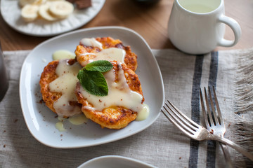 Breakfast of pancakes with cottage cheese with condensed milk and fruit