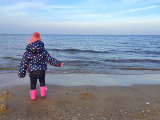 child by the baltic sea in autumn