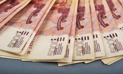 Russian rubles are laid out on a gray background