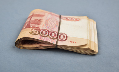 Russian rubles are laid out on a gray background