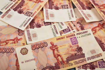 Russian rubles are laid out on a gray background