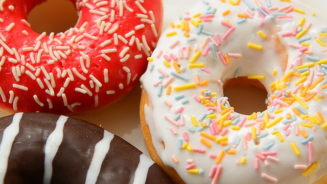 Donuts with sprinkles. Close up of colourfull donuts.