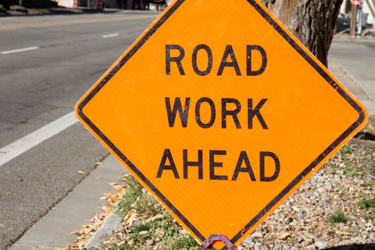 Road work ahead sign on the side of the road