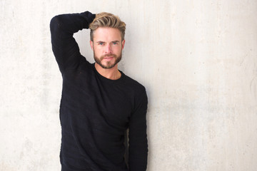 Male fashion model posing with hand in hair